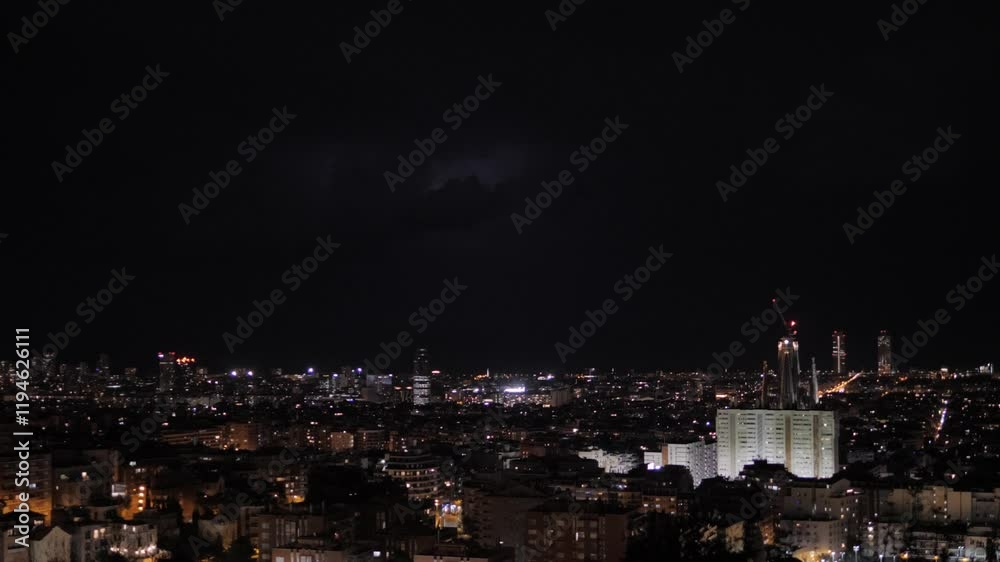 Thunderstorm over Barcelona urban area. Extreme Lightning electrical flashes and thunderbold in clouds illuminate city and sea at night. Natural phenomena, climate, meteorology, and weather forecast.