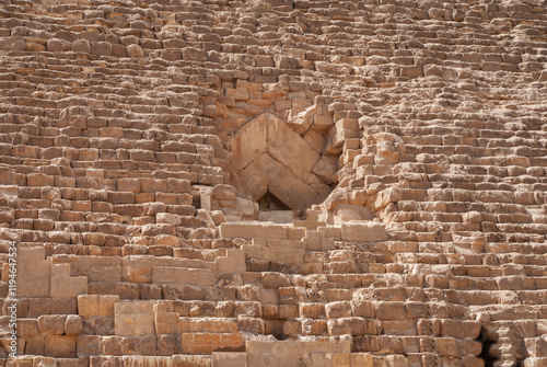 Giza Pyramid Complex is complex of ancient monuments on Giza Plateau. Tourists and locals take in sights of the Pyramid of Cheops, largest of Egyptian pyramids. Cairo, Giza, Egypt - April 18, 2008