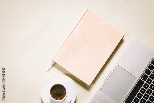 bright feminine banner or header with a coffee, stylish workspace with laptop computer, modern office accessories and a small notebook on a blush table, top view, flat lay photo