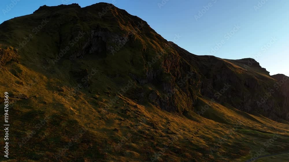 custom made wallpaper toronto digitalThe sun casts a golden glow over the rugged cliffs and slopes of Iceland’s untouched wilderness, showcasing the stunning textures and colors of the landscape in the early morning light.