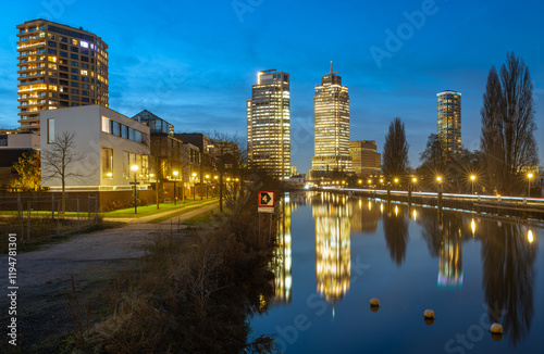 Photography Amsterdam skyline at night, skyscrapers at Omval neighbourhood mirrored at Weesp