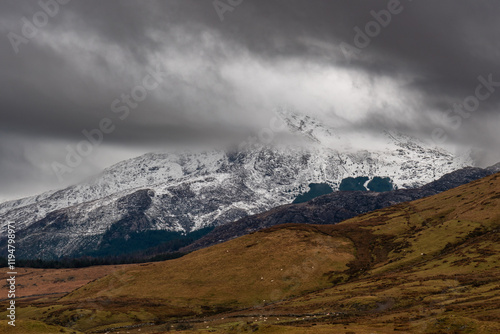 Snow capped and mist covered summit of Moel Hebog mountain in Snowdonia photo