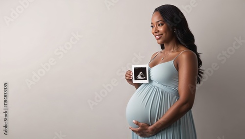 Pregnant African American woman holding an ultrasound photo. Ideal for maternity, health, and parenting. Copy space for text