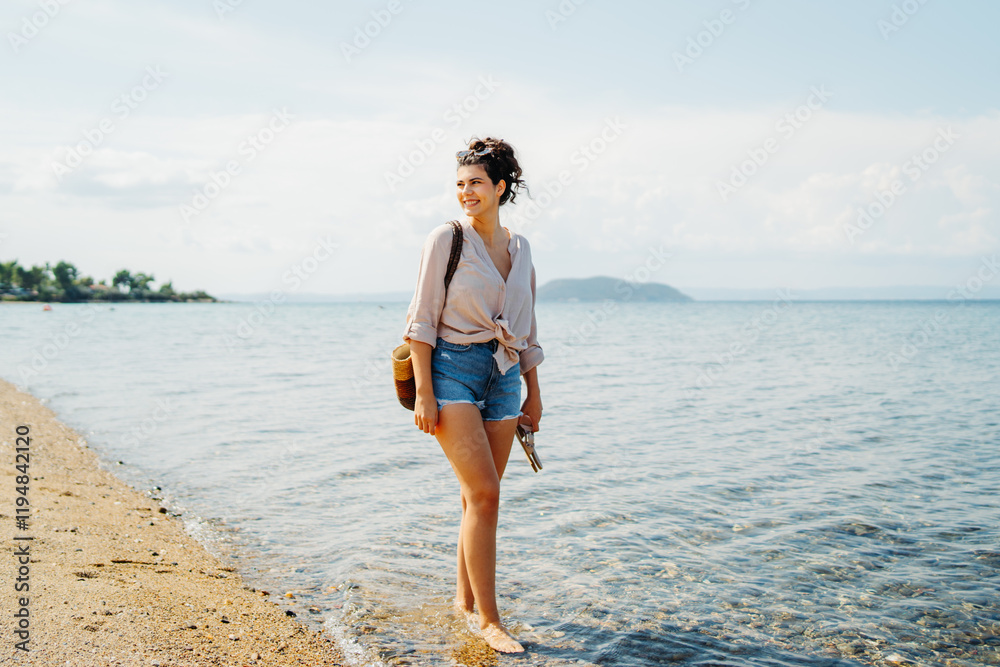 Young caucasian woman is going to the beach with straw bag
Young caucasian woman is going to the beach with straw bag