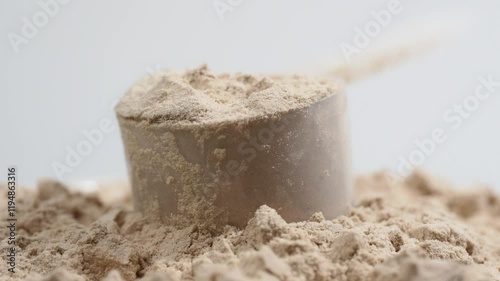 Protein powder in a measuring spoon. Bodybuilding, fitness and lifestyle in the gym. The concept of sports, health and nutrition