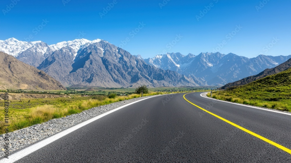 Naklejka premium Asphalt road through majestic mountains