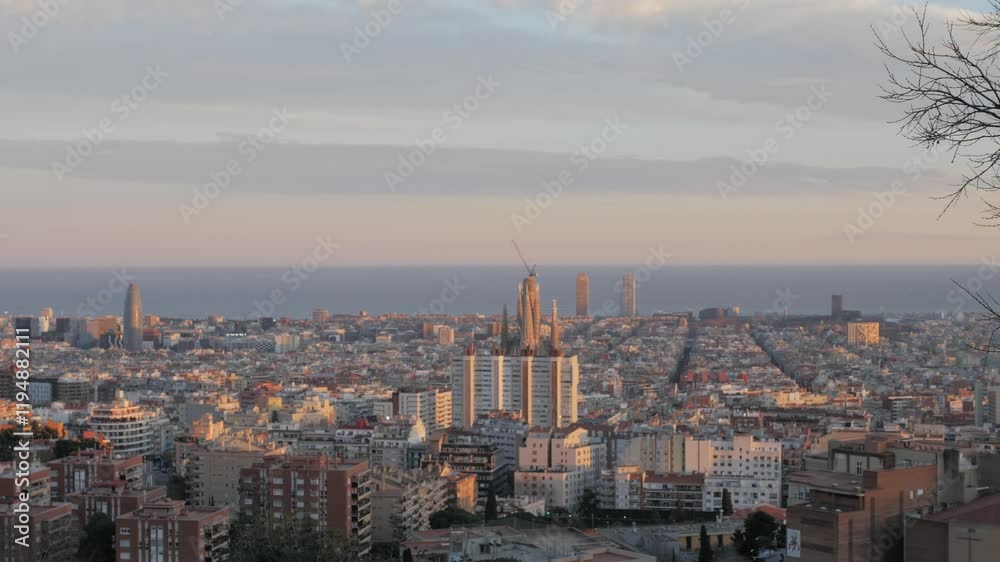 Panoramic view of Barcelona from Juan Sales viewpoint. Sunset light falls on the city buildings. Sagrada familia, tower Agbar in golden hour. Urban concept. Panoramic view of Barcelona from Juan Sales viewpoint. Sunset light falls on the city buildings. Sagrada familia, tower Agbar in golden hour. Urban concept.