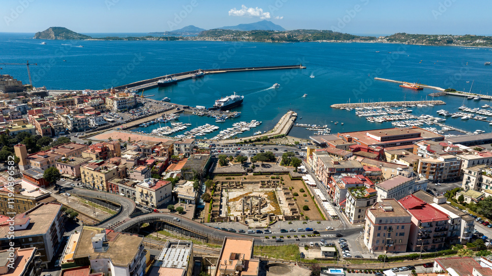 Obraz premium Aerial view of the marina located in Pozzuoli, near Naples, Italy.In background are the Tyrrhenian Sea and the promontory of Capo Miseno.
