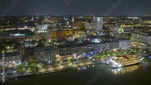 Wallpaper Mural Savannah, Georgia. Old historic River Street and riverboat sailing on water. View from above of illuminated streets at night. USA tourist attraction. Torontodigital.ca