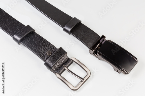 Two black leather belts with conventional and clamping buckles photo