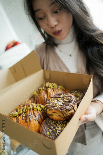 Happy Face Expression from beautiful young Asian Lady, gets a gift pastry box.