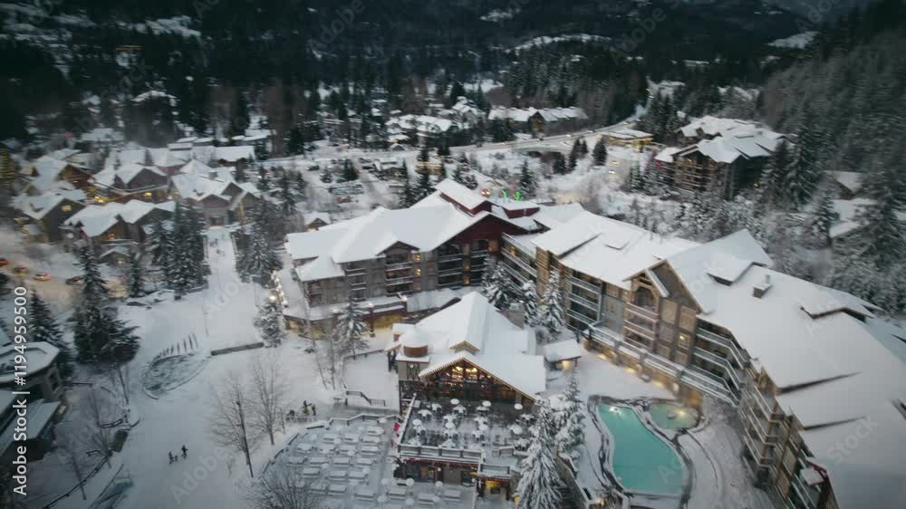 A massive, stunning hotel covered in snow located in the mountains of British Columbia, Canada. A massive, stunning hotel covered in snow located in the mountains of British Columbia, Canada.