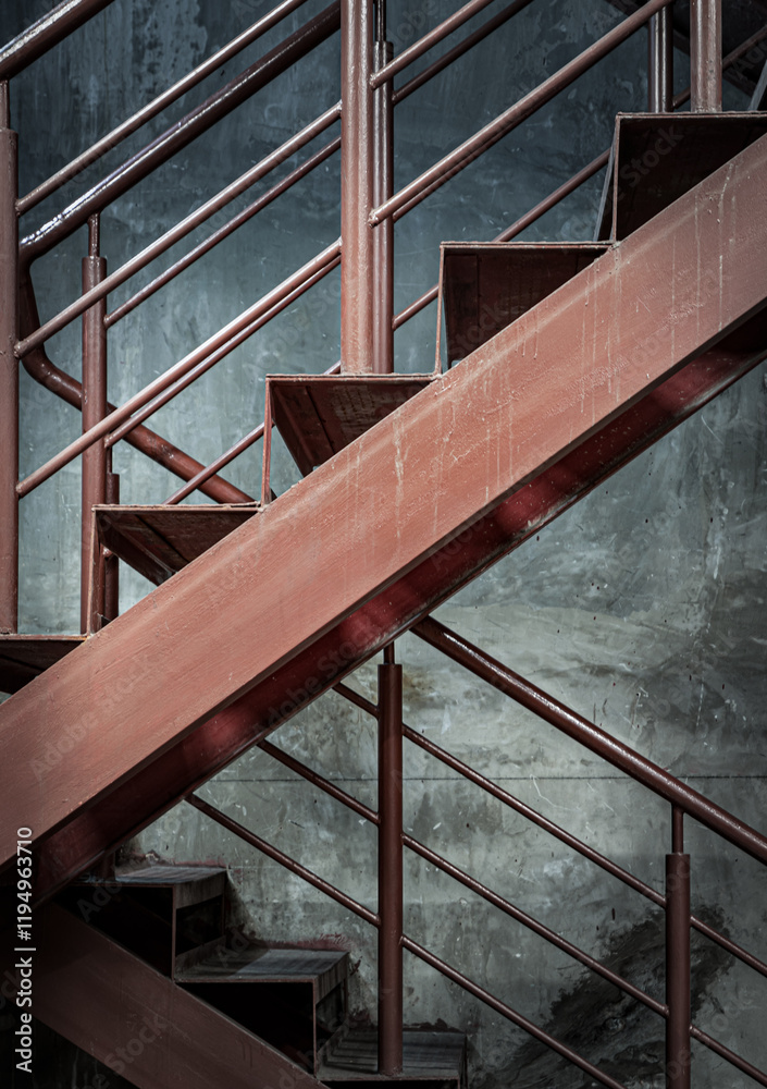 Vertical view of Old Steel ladder with handrails with concrete wall in the background. Side view of Metal steps, Dark tone, Copy space, Selective Focus.