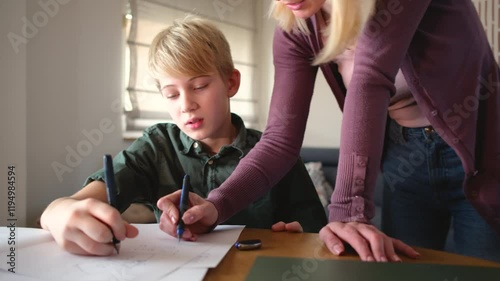 A mother, helping her son with his homework. They are using a laptop to search for information and solve tasks together.