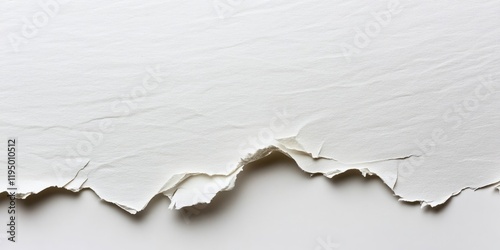 Torn edge of textured white paper sheet on a smooth light background with subtle shadows creating depth and dimension at the bottom edge.