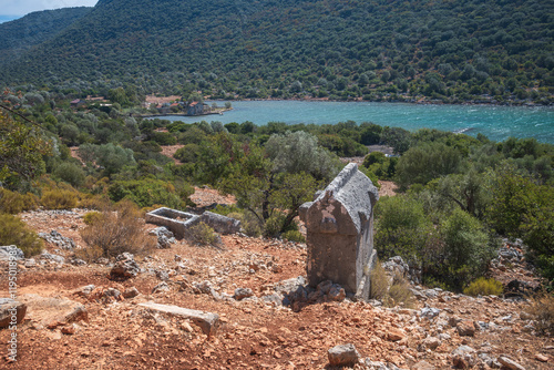 lycian sarcophagi on a high peak facing to the secluded gulf photo