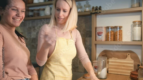 A mother and her children are in the kitchen preparing dough together for baking cakes, working side by side and enjoying the process.
