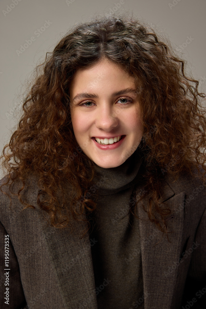 Cheerful smiling, happy, joyful young woman looking at camera against grey studio background. Model dressed casually. Concept of human emotions, self-expression, fashion and style. Cheerful smiling, happy, joyful young woman looking at camera against grey studio background. Model dressed casually. Concept of human emotions, self-expression, fashion and style.