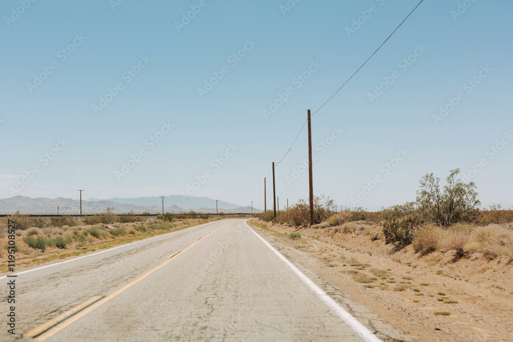 An old desert road in California. Panoramic view with an empty road in the desert. An old desert road in California. Panoramic view with an empty road in the desert.