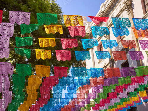 Papel Pecados, a traditional Mexican folk art, hanging over a street in downtown, Puebla.