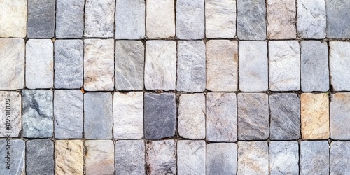 Paved stone pathway texture with gray and beige slabs arranged in a grid pattern featuring natural variations and copyspace for design use.