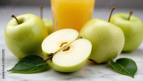 Fresh Sliced Green Apple with White Interior and Apple Juice on Marble Surface photo