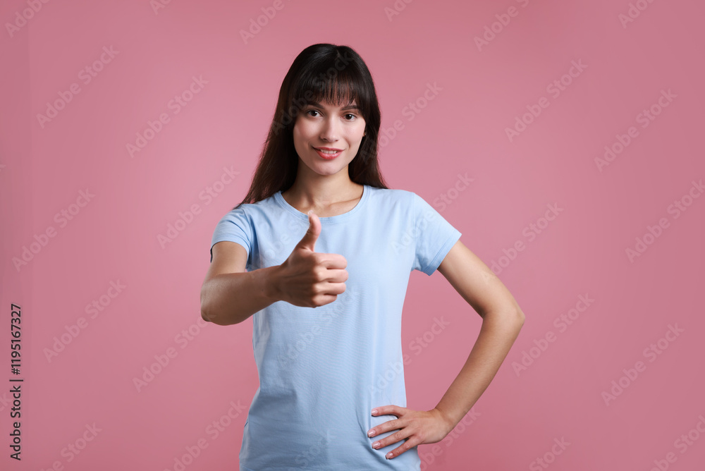 Happy woman showing thumbs up on pink background. Like gesture Happy woman showing thumbs up on pink background. Like gesture