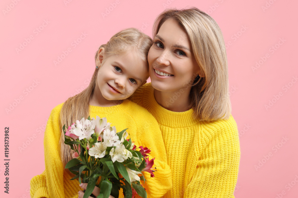 Happy woman with her daughter and bouquet of alstroemeria flowers on pink background. Mother's Day celebration Happy woman with her daughter and bouquet of alstroemeria flowers on pink background. Mother's Day celebration