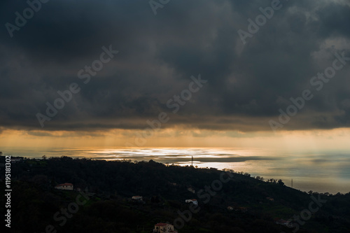 sunset over the Tyrrhenian Sea during a spring day with a cloudy sky, seen from Maierà, Cosenza