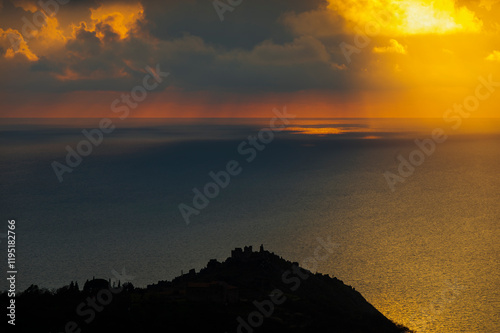 sunset over the Tyrrhenian Sea during a spring day with a cloudy sky, seen from Maierà, Cosenza photo