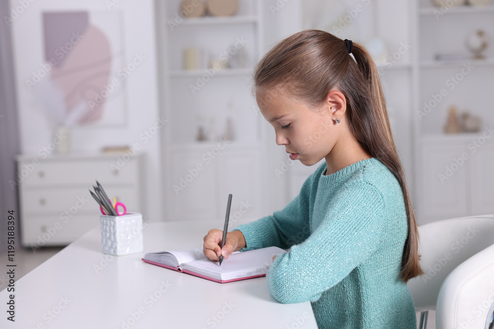 Girl with correct posture doing homework at white desk indoors