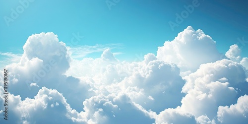 Fluffy white clouds illuminated by sunlight against a bright blue sky with soft gradients in the upper and lower sections of the image