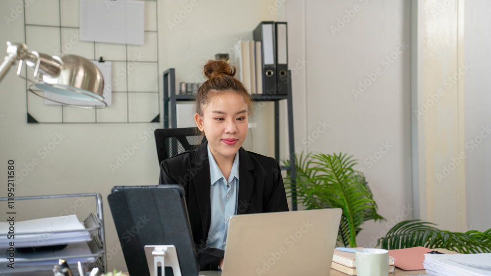 Businesswoman sitting at desk on couch in workplace or at home working on laptop and analyzing data on charts and graphs and writing on papers to make business plan and strategies for company. Businesswoman sitting at desk on couch in workplace or at home working on laptop and analyzing data on charts and graphs and writing on papers to make business plan and strategies for company.