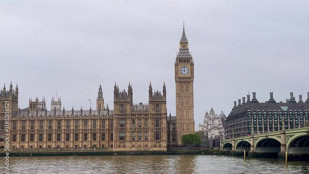 Big Ben and Houses of Parliament stand majestically by the River Thames, framed by Westminster Bridge, slow motion Big Ben and Houses of Parliament stand majestically by the River Thames, framed by Westminster Bridge, slow motion