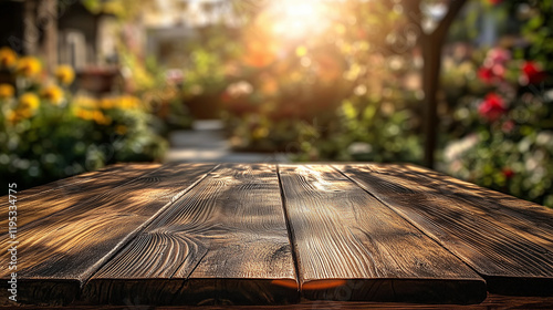 Empty wooden table top with blurred morning garden background. Sunlight and natural lens flare create a warm, atmospheric setting, ideal for outdoor product presentation or natural lifestyle concepts. photo