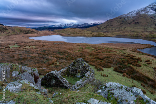 Old derelict cottage above Llyn y Dywarchen glacial lake photo