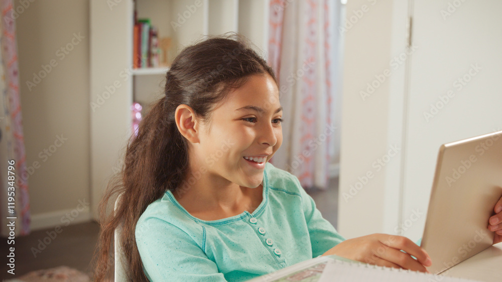 Smiling Young Girl Sitting At Desk In Bedroom At Home Using Digital Tablet Smiling Young Girl Sitting At Desk In Bedroom At Home Using Digital Tablet