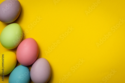 Easter egg decoration on yellow background with space for text