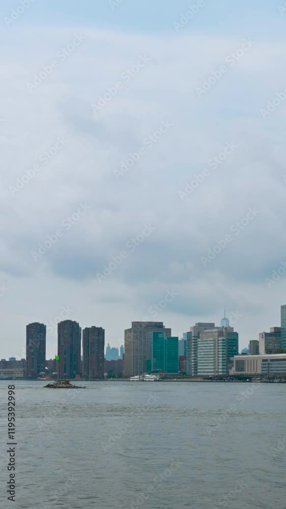 New York, USA, August 17, 2024. Beautiful vertical footage with pan movement. The view sweeps across the Manhattan cityscape to the Williamsburg Bridge in the background. Travel destinations. New York, USA, August 17, 2024. Beautiful vertical footage with pan movement. The view sweeps across the Manhattan cityscape to the Williamsburg Bridge in the background. Travel destinations.