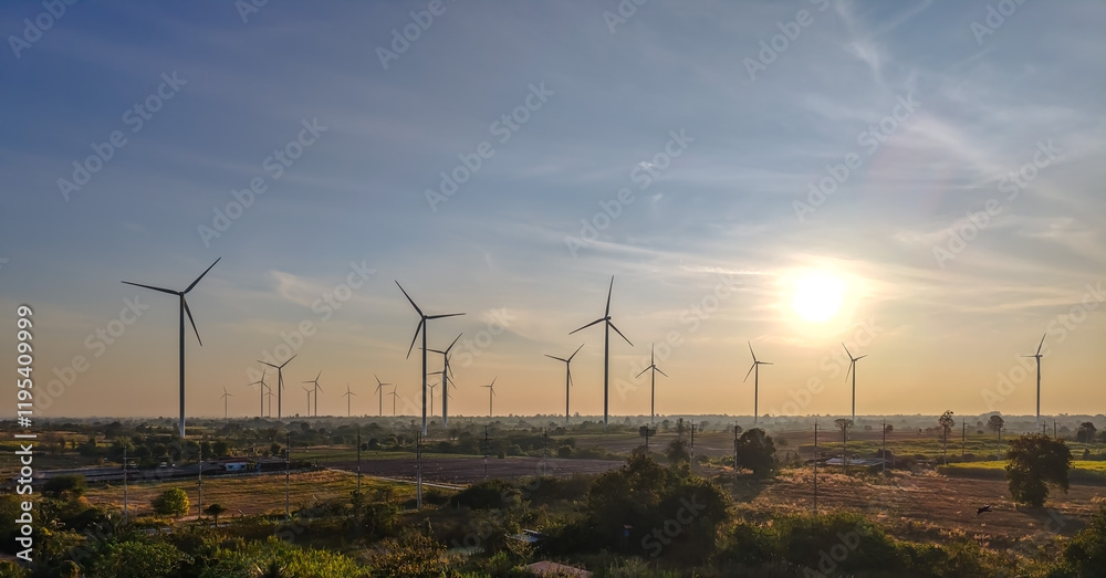 Obraz premium Beautiful landscape group of wind turbines standing in field for sustainable energy on sunset