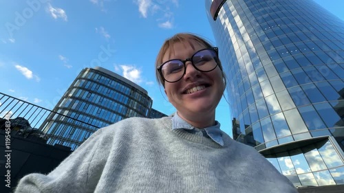 Happy successful young woman office worker or university student outdoors celebrating success