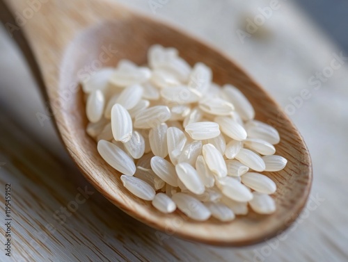 Close-up of rice grains on a wooden spoon. Featuring the texture and purity of uncooked rice. Emphasizing natural and wholesome food. Ideal for cooking blogs and recipe books. photo