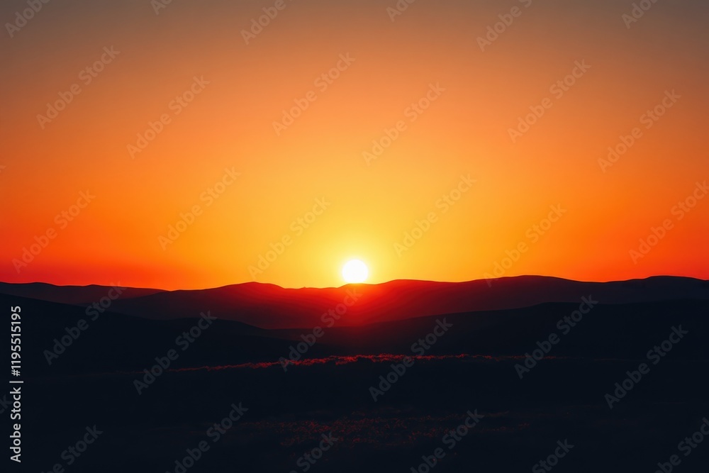 Fototapeta premium Fiery Sunset Over Silhouetted Mountain Range