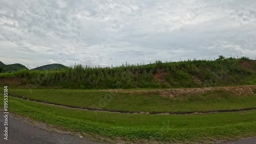 car passing by the road, the bridge, the highway, red car tip, river with clay
