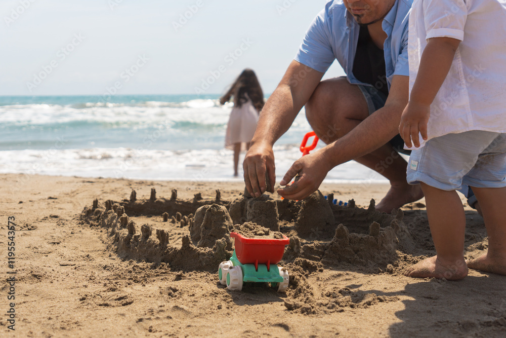 Father and son enjoying quality time together, building a sandcastle on a sunny beach during their summer vacation Father and son enjoying quality time together, building a sandcastle on a sunny beach during their summer vacation