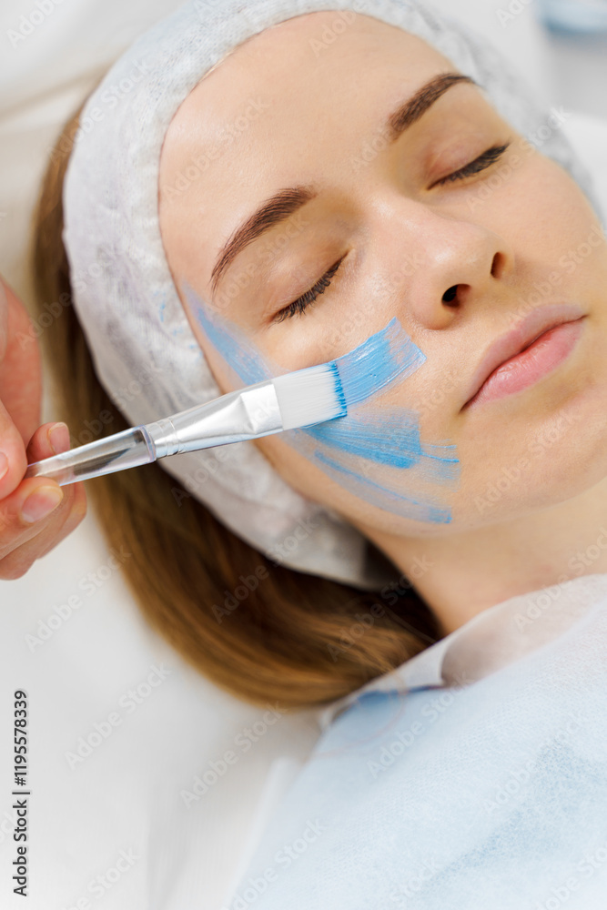 Applying face mask for skincare wellnesses and humidification in spa. Getting facial treatment for a women with moisturizing mask by cosmetologist. Applying face mask for skincare wellnesses and humidification in spa. Getting facial treatment for a women with moisturizing mask by cosmetologist.