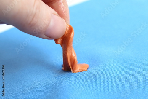 Tableau sur toile A woman's hand peels gum off her clothes.