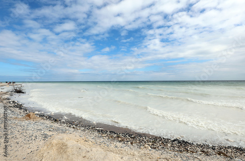 Fototapeta Naklejka Na Ścianę i Meble -  beach of sand and smooth pebbles and the whitish sea