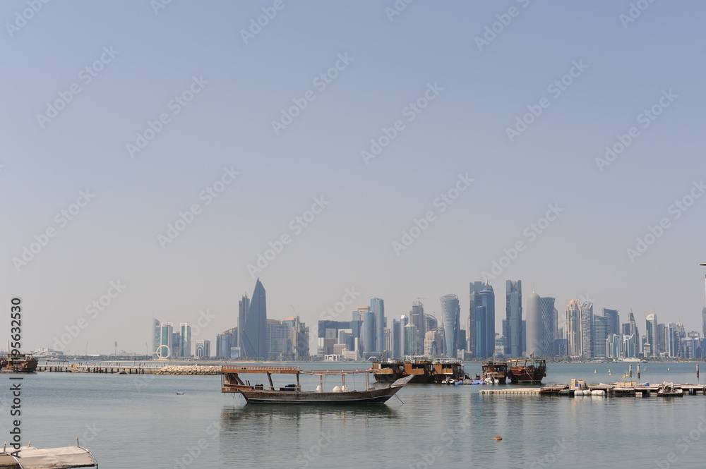 Fototapeta premium Panoramic view of modern skyscrapers of Doha capital city cityscape on a sunny day in summer, Doha, Qatar