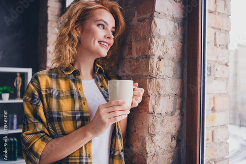 Photo of lovely young blonde girl drinking coffee mug look window ressed yellow plaid garment spacious house indoors room photo